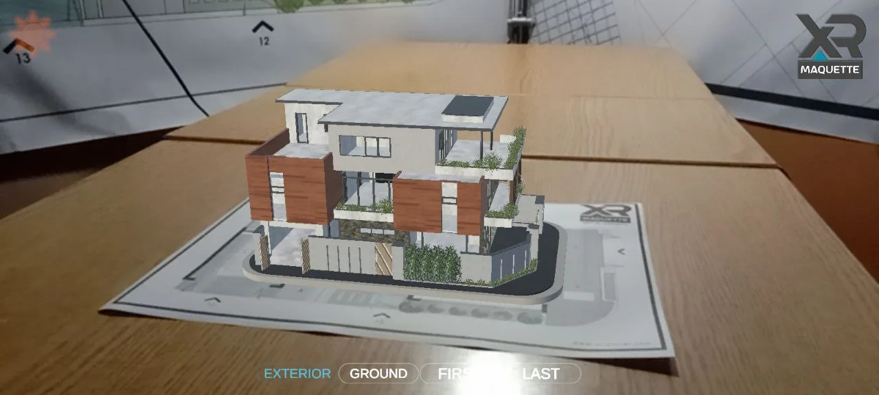 A building model placed on a table at true scale through a phone camera